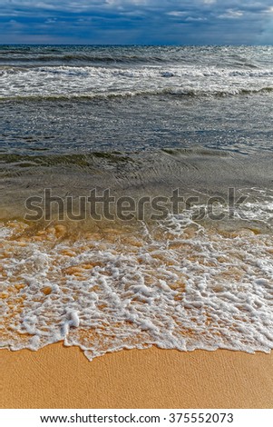 Stormy Mediterranean sea waves over tropical sandy beach