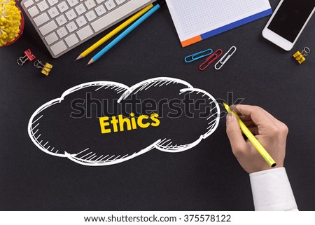 Man working on desk and writing Ethics