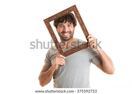 Portrait of a happy man holding picture frame