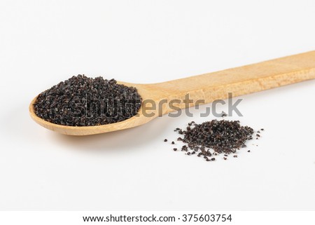 spoon of poppy seeds on white background