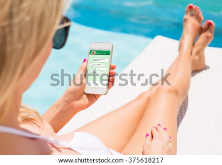 Woman messaging with friend on her smartphone Royalty-Free Stock Photo #375618217