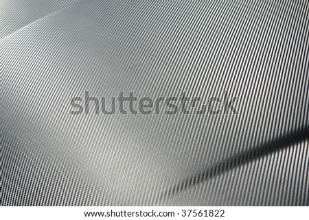 A closeup of real carbon fiber material, an excellent texture or background. Shallow depth of field.