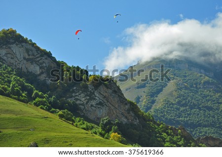 Para gliders flying in mountains