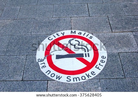 Attention, caution sign for smoke free city malls in outdoor pedestrian zone in Australian town, Australia