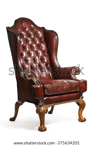 old antique brown/red leather wing arm chair eighteenth or nineteenth century Royalty-Free Stock Photo #375634201