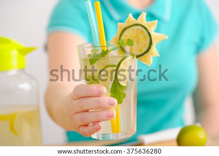 Closeup of a woman with fruit in a glass of water healthy eating, drinks, diet