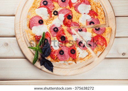 Italian pizza on the wooden background