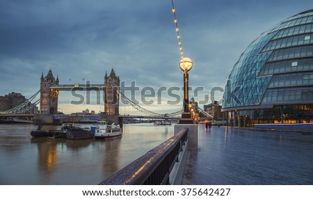 The world famous Tower Bridge with the City Hall building on an early winter morning - London, UK