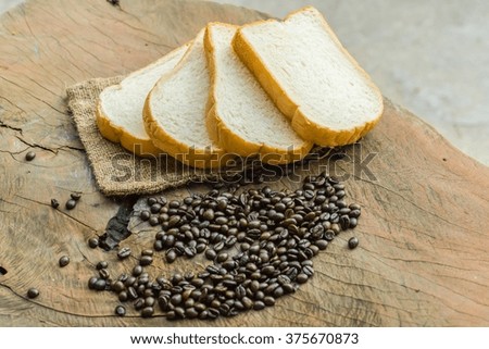 Rich & soft Sliced bread and coffee beans on wooden background fresh bread on the wooden board