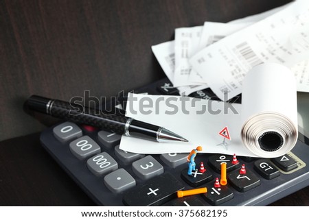 The calculator receipt and maintenance figure miniature model represent the business and finance concept related idea. 