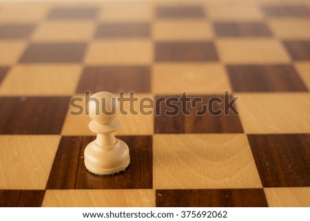 wooden chess set, white pawn on board