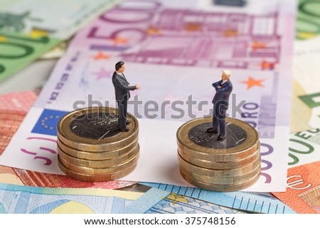 Miniature businessmen on money