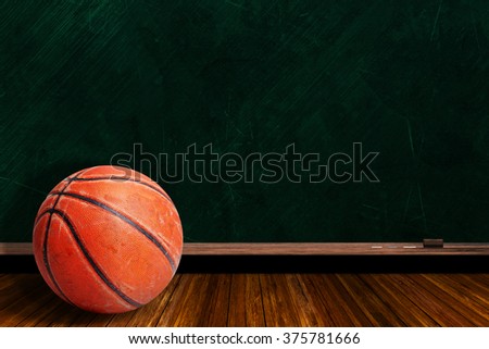 Rugged and seasoned basketball on a background chalk board with copy space.