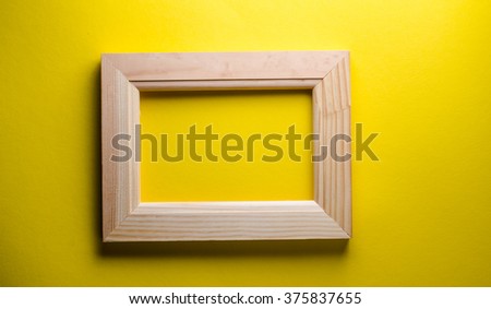 wooden frame on a yellow background