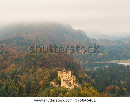 Hohenschwangau Castle, Alpsee bei Schwangau, Schwansee Lake in the Mist, Aerial View Panoramic in Autumn Season red maple fall foliage, Bavaria, Germany