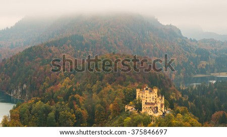 Hohenschwangau Castle, Alpsee bei Schwangau, Schwansee Lake in the Mist, Aerial View Panoramic in Autumn Season red maple fall foliage, Bavaria, Germany