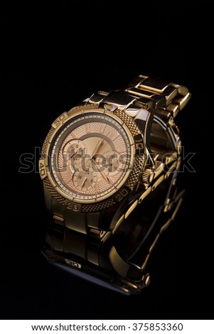 Gold watch on a monochrome plastic background, studio lighting, Macro