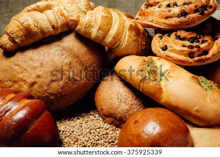 Assortment of baked delicious bread on wood table