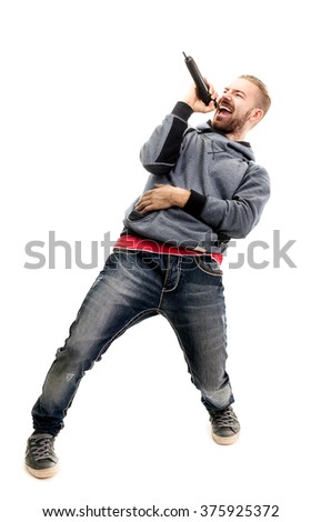 studio portrait of a man singing with microphone isolated on white background, a nice young man with blond hair singing with drive. Royalty-Free Stock Photo #375925372