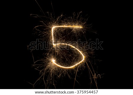 number from sparkler on black background