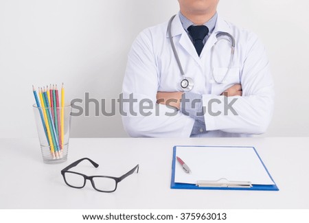 doctor sitting at his desk, medical equipment and desktop on background, medical records on a blank sheet, Medical clipboard, laptop