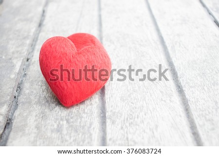 Red heart on rustic wood