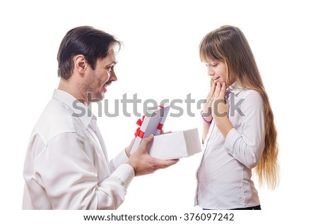 The father grants to the daughter a gift in a white box with a red bow