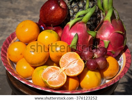 This tray is composed of various fruit such as red grape, banana, orange and apple, a sacrificial offering in Chinese New Year.