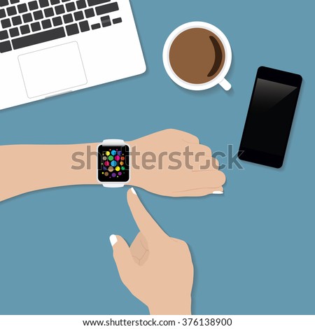 hand using smart watch similar to apple watch style on desk