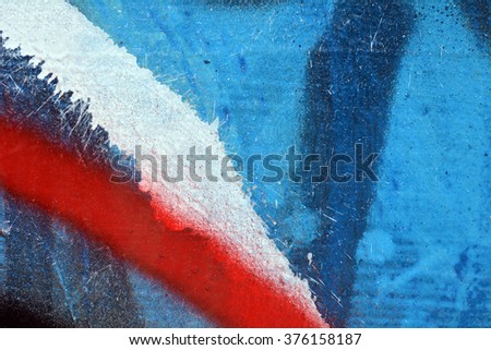Wall painted blue red white black paint. Macro photo