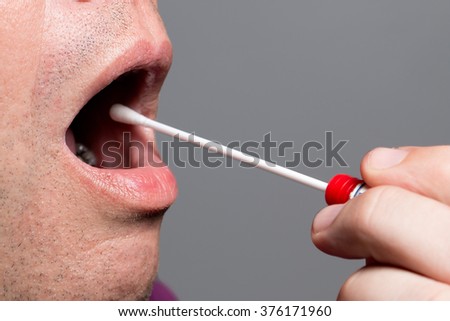 Man use a DNA test tube and cotton swab, wipe test Royalty-Free Stock Photo #376171960