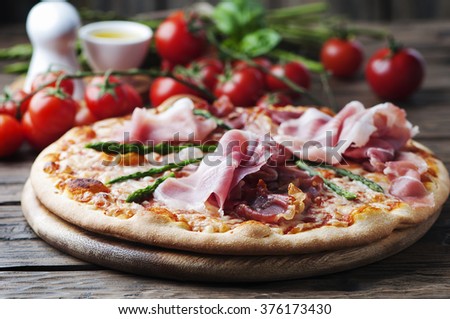Italian pizza with ham and asparagus, selective focus