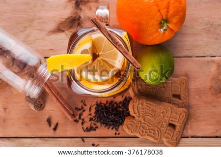 Photo of Hot spiced tea in jar on wooden table