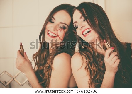 Pretty girl having fun in bathroom. Funny concept during makeup. Draw of heart. Retro style