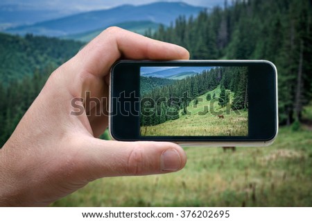 people photographed on a smartphone, selfie phone, taking pictures on smartphone mountain scenery