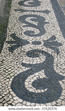 cobblestone street in Lisbon with floral pattern