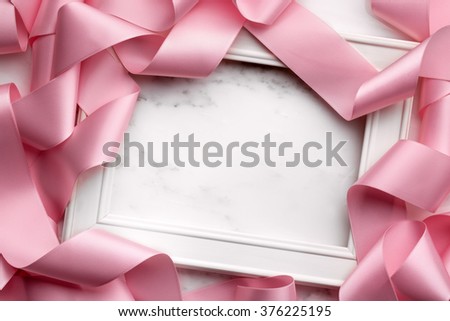 Blank picture frame wrapped in gift ribbon