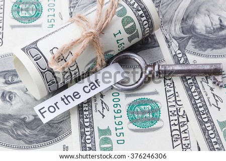 Money and business idea, The dollar bills tied with a rope, with a sign on key fob - For the car