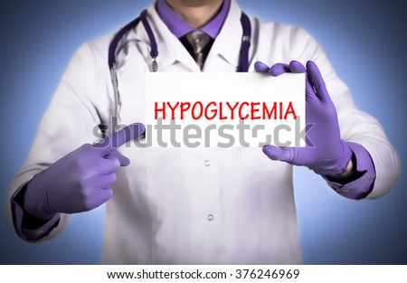 Doctor keeps a card with the name of the diagnosis - hypoglycemia. Selective focus. Medical concept. Royalty-Free Stock Photo #376246969