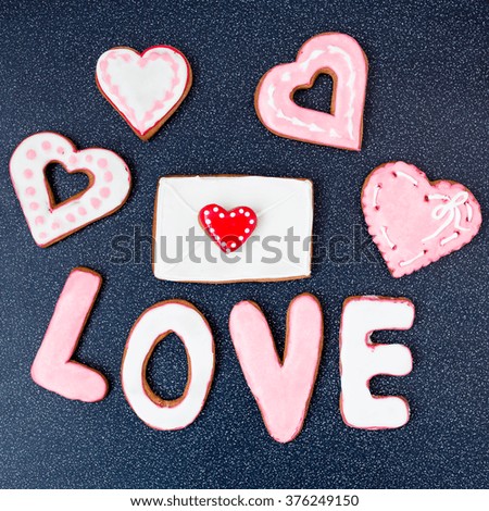 Heart cookies with letter on dark background
