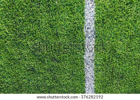 A top down angle view of white line on a green soccer field. Royalty-Free Stock Photo #376282192