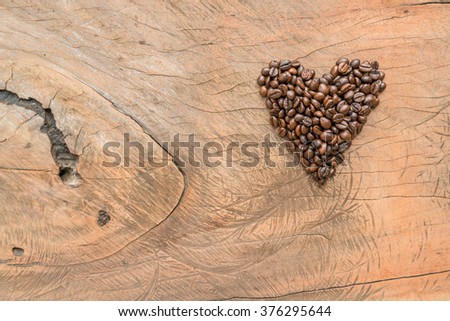 Valentines Heart shape coffee made of coffee beans on Scartch wooden texture - For Your text & design 