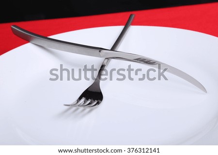 fork and knife with red background