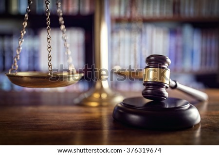 Judge gavel, scales of justice and law books in court Royalty-Free Stock Photo #376319674