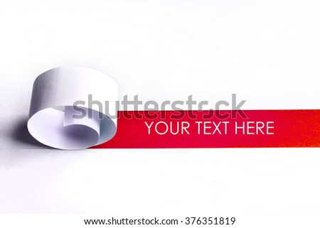 Cutted and rolled white paper with red space for text