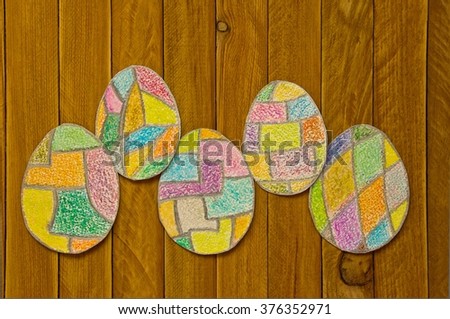 painted colorful Easter eggs on a wooden table. I myself drew these pictures