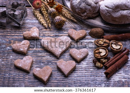Cookies and biscuits in the form of heart.  Ingredients  for baking cookies, biscuits, flour, eggs, butter, baking dish  on a wooden background.
