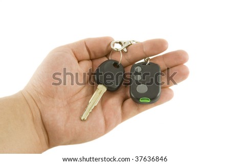 Hand holding key and car alarm system isolated on white background
