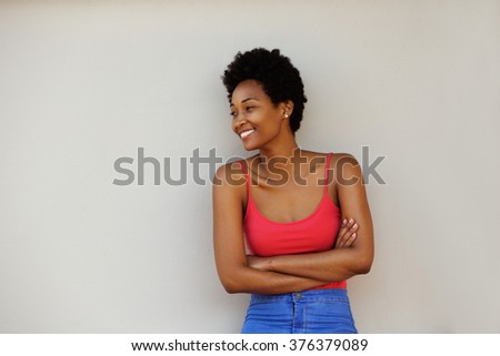 Portrait of an attractive young african woman standing with her arms crossed and looking at copy space