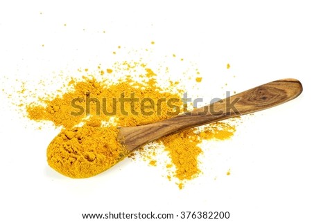 turmeric powder on a wooden spoon isolated on white background